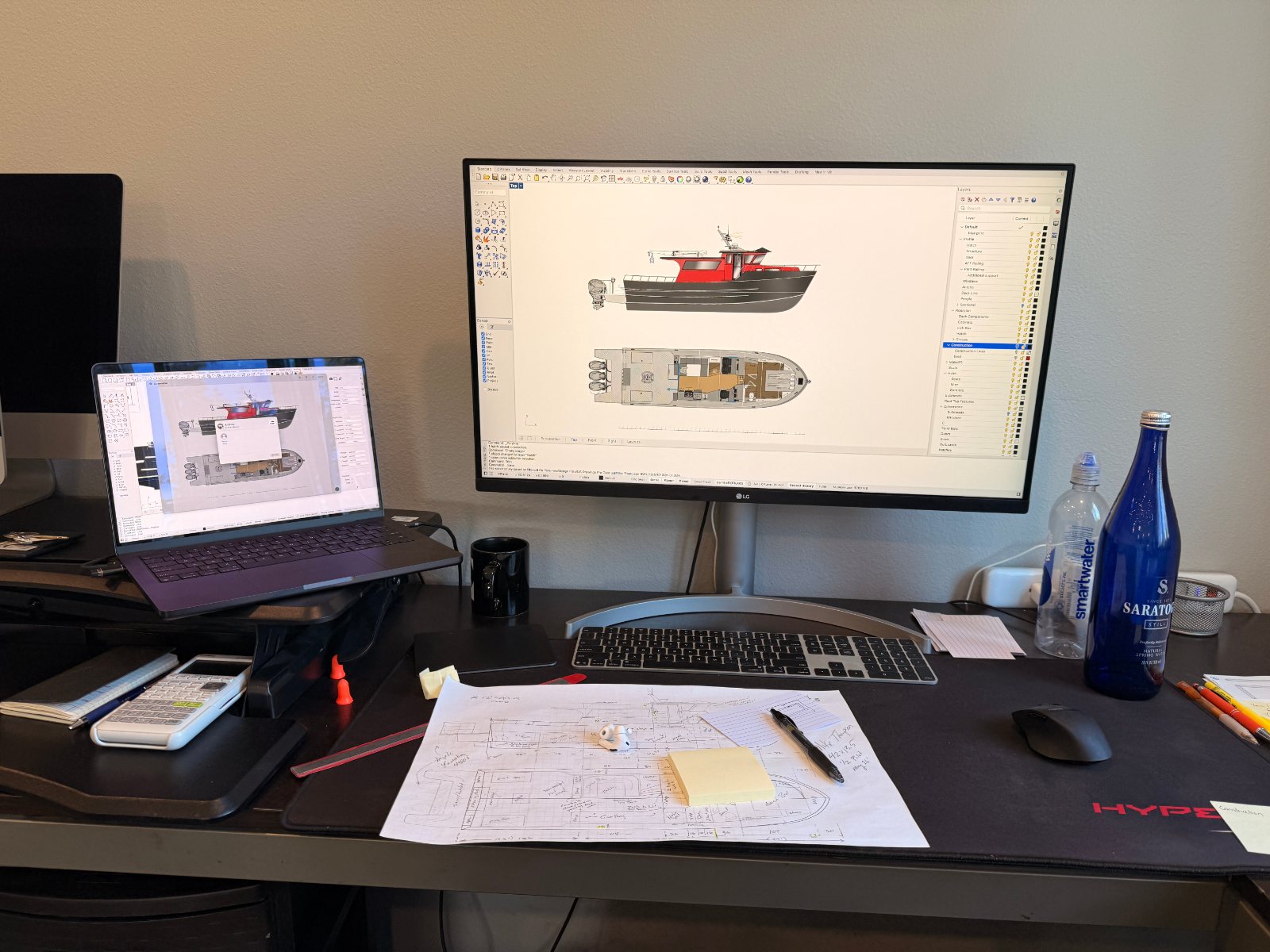 Monitor showing a red-hulled boat arrangement in Rhino