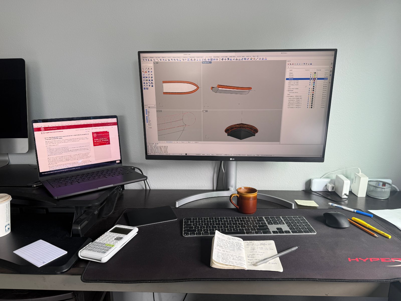 Monitor showing hull lines in Rhino beside handwritten notes